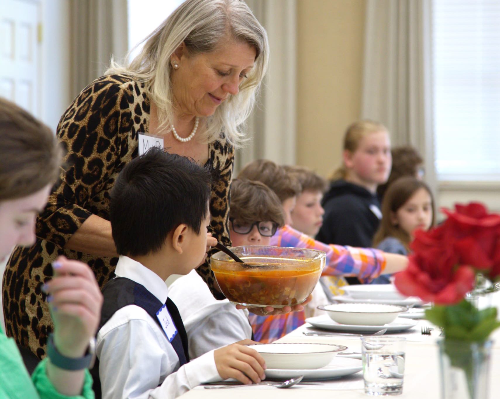 Etiquette students learning to eat soup