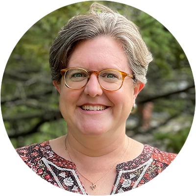 Amy Wagliardo, Executive Director, Headhsot, smiling woman with glasses