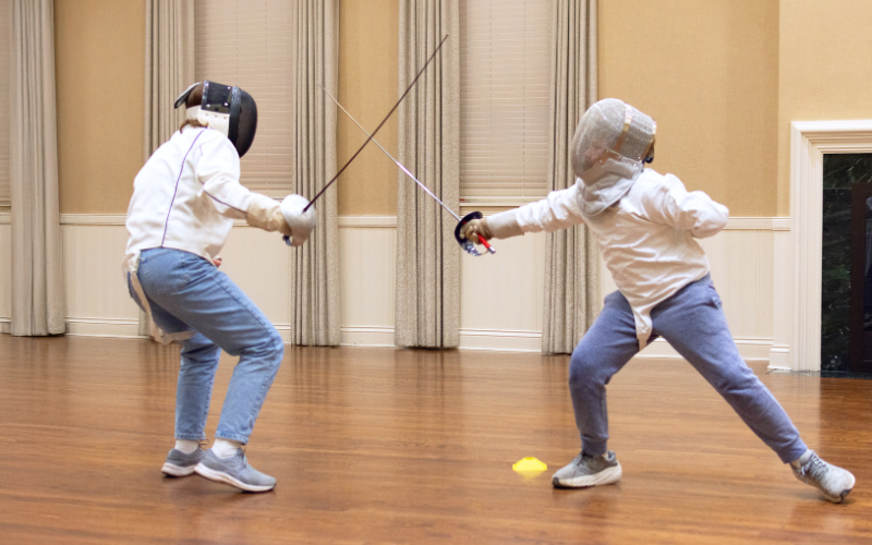 two fencing students in a practice bout