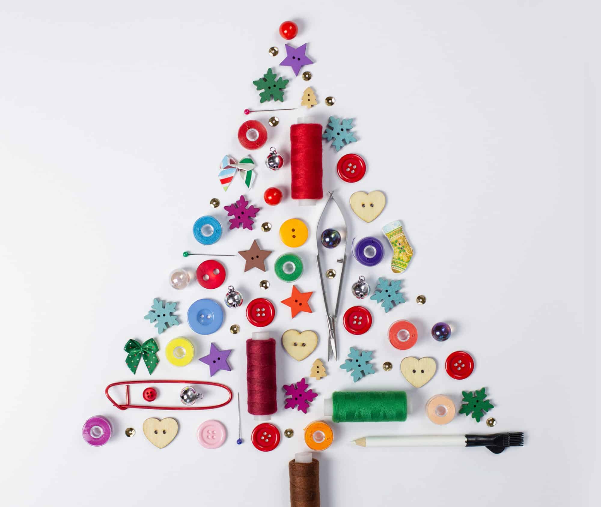 thread, buttons and other sewing supplies made into a tree shape