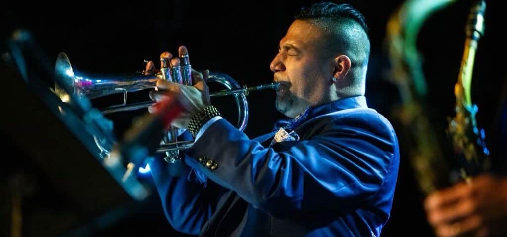 victor garcia playing the trumpet on stage