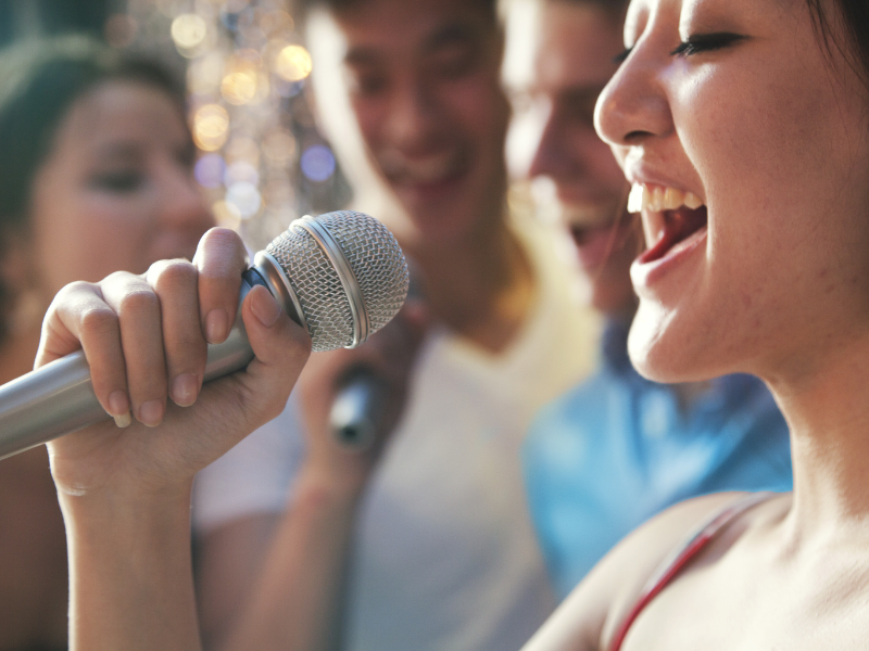 Group of people singing karaoke