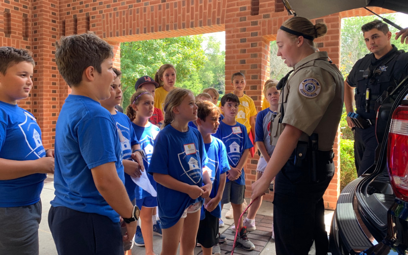 Summer camp attendees listening to Police Deputies about safety