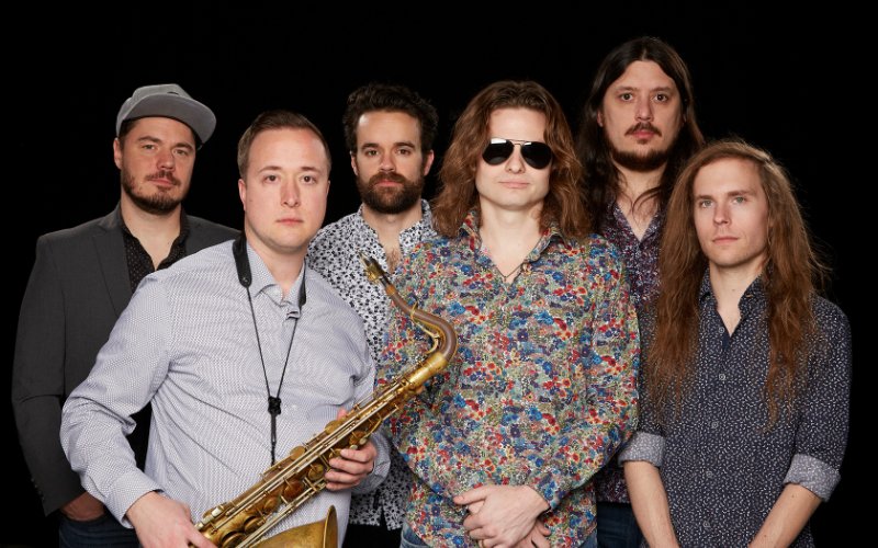 Six male members of The Brooklyn Charmers band pose for a portrait