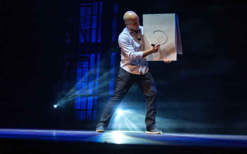 Magician Bill Blagg performs on stage