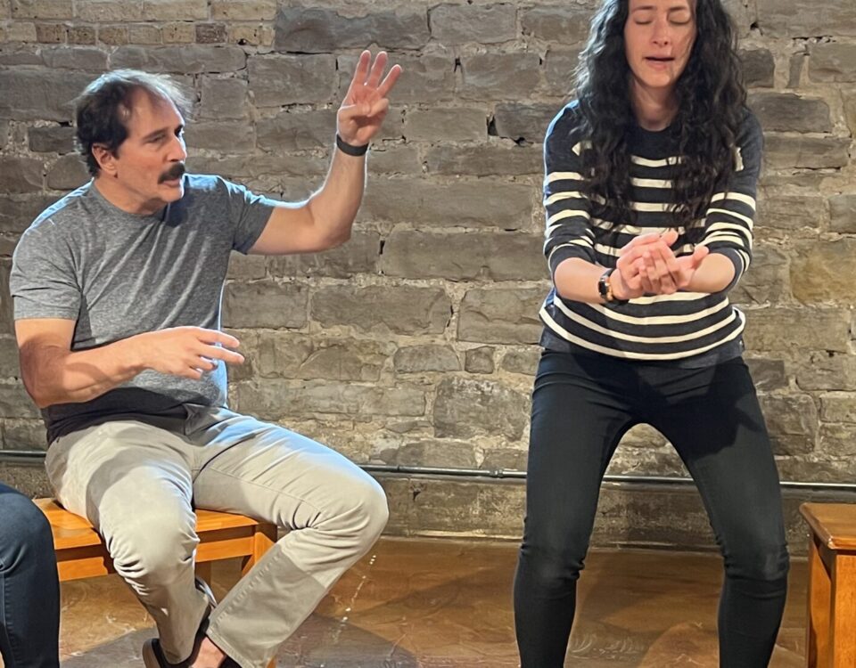 Two adults acting out an improvised scene