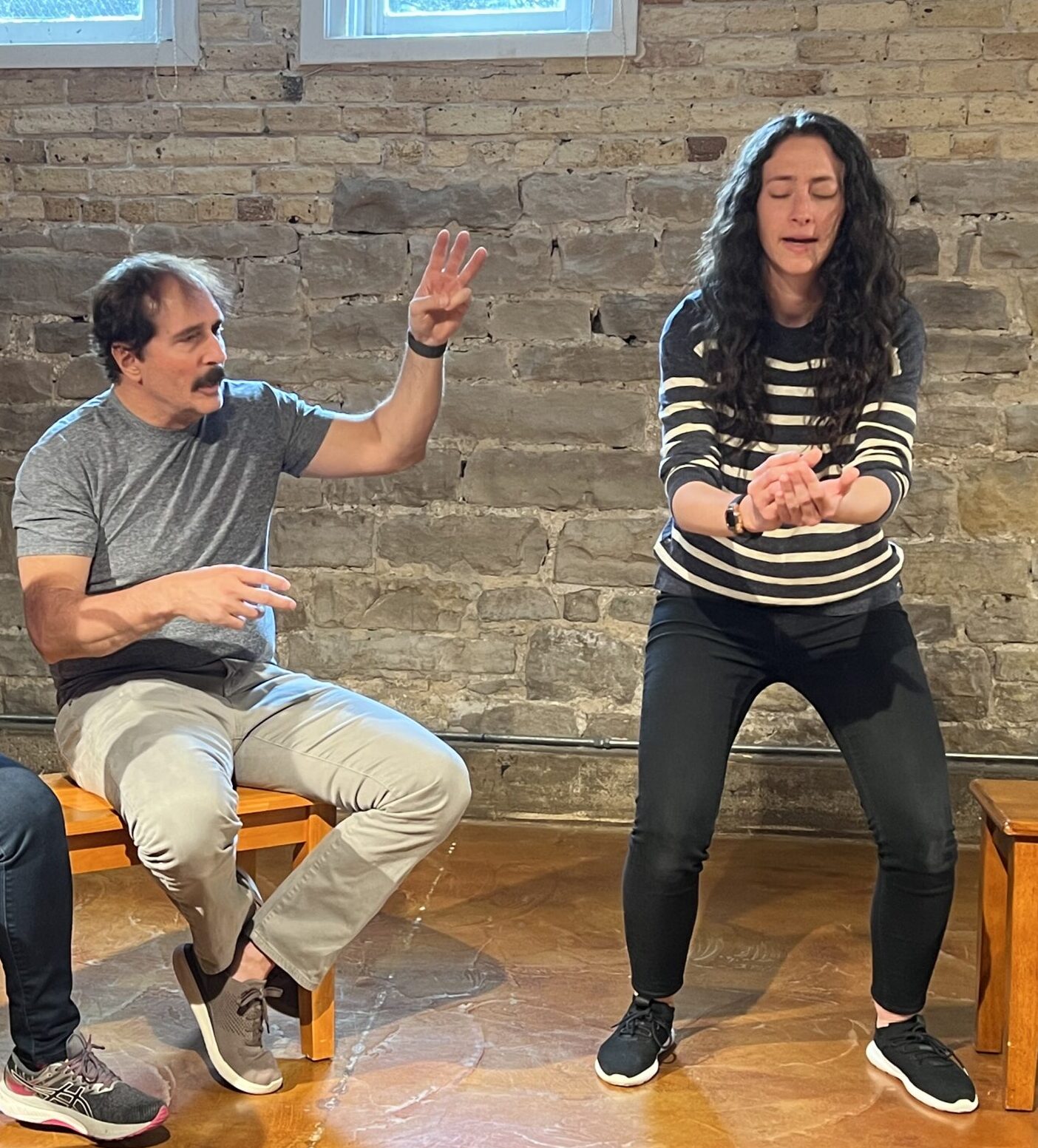 Two adults acting out an improvised scene