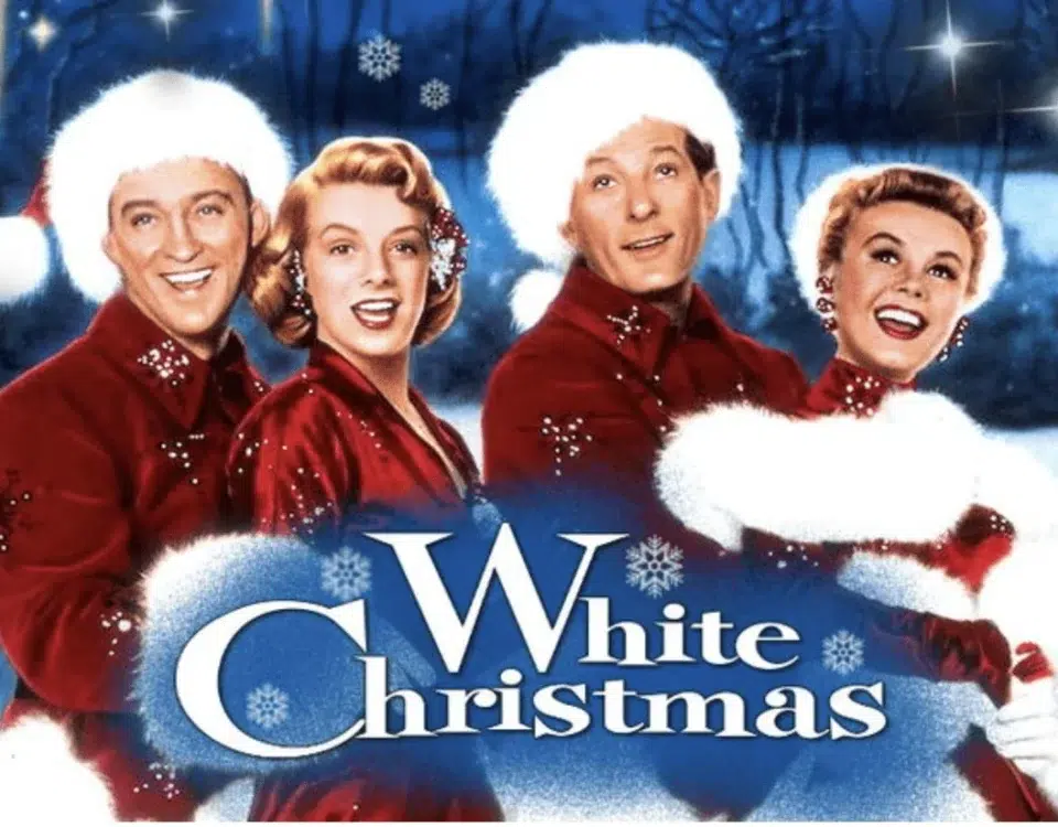 Bing Crosby, Rosemary Clooney, Danny Kaye and Vera Ellen dressed in red and white holiday themed suits standing in front of a winter background for the promotional poster for White Christmas