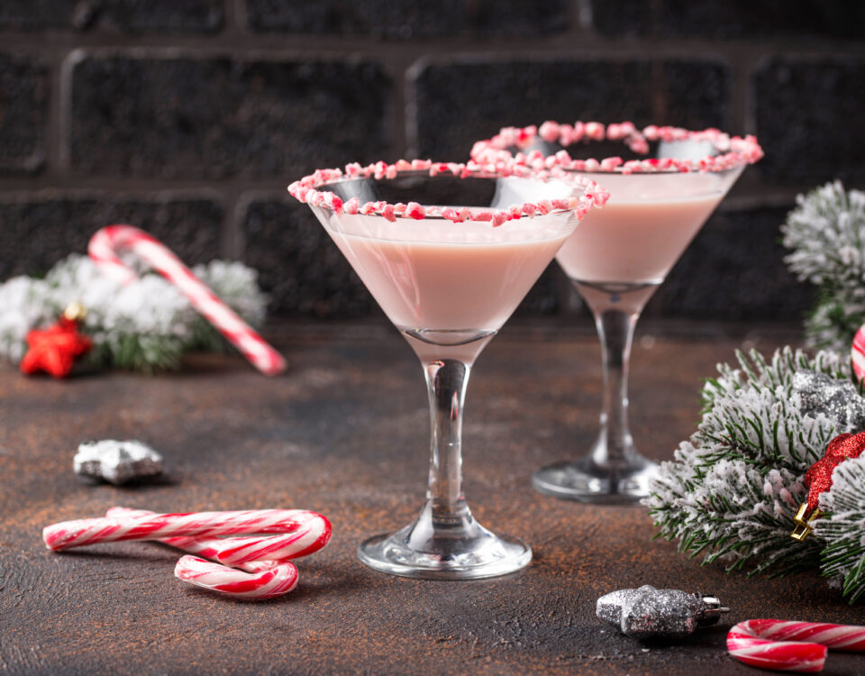 Pink peppermint martini with candy cane rim