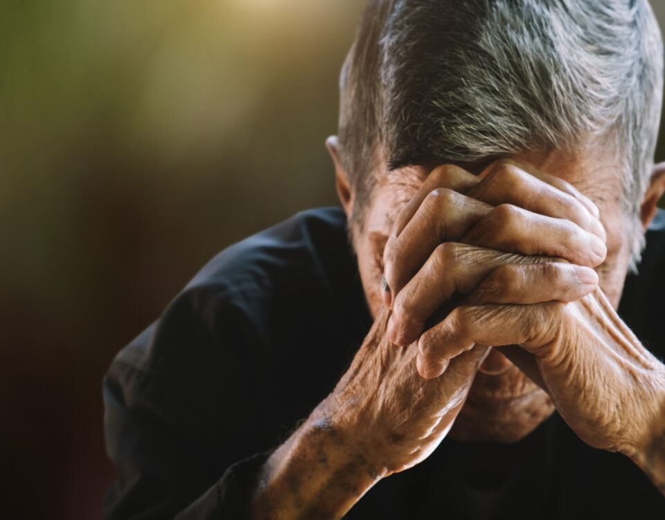 senior man covering his face with his hands. Depression and anxiety Copy space.