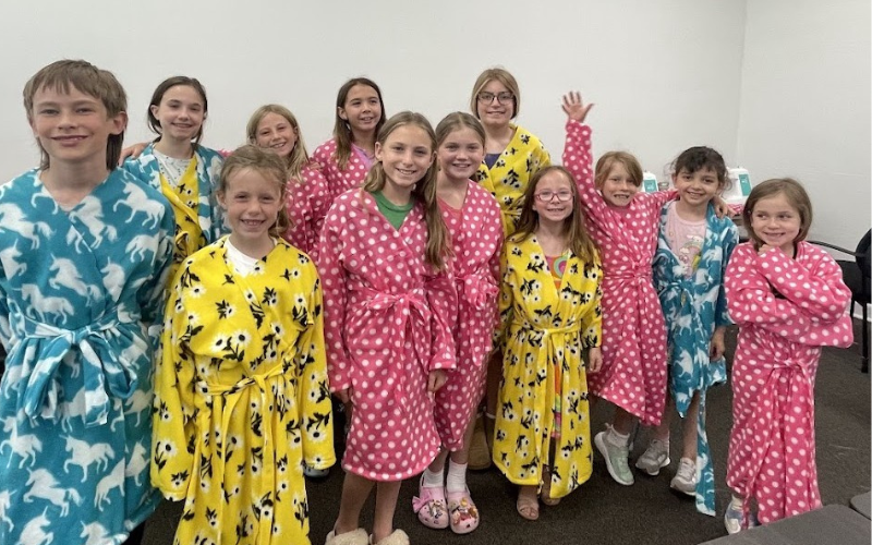 A group of kids proudly modeling the robes they made at Ciao Bella's pajama party sewing camp