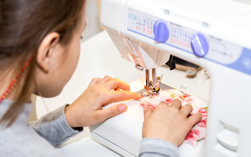 girl using sewing machine