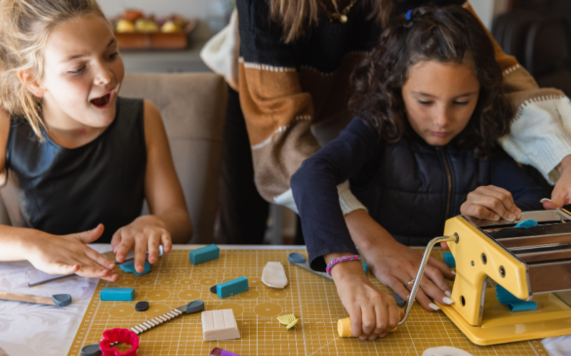girls at jewelry camp making jewelry with machines