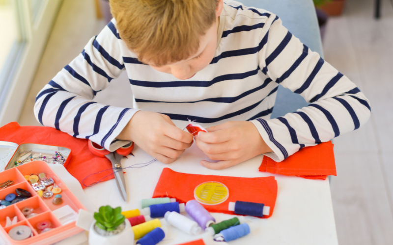 boy using sewing materials