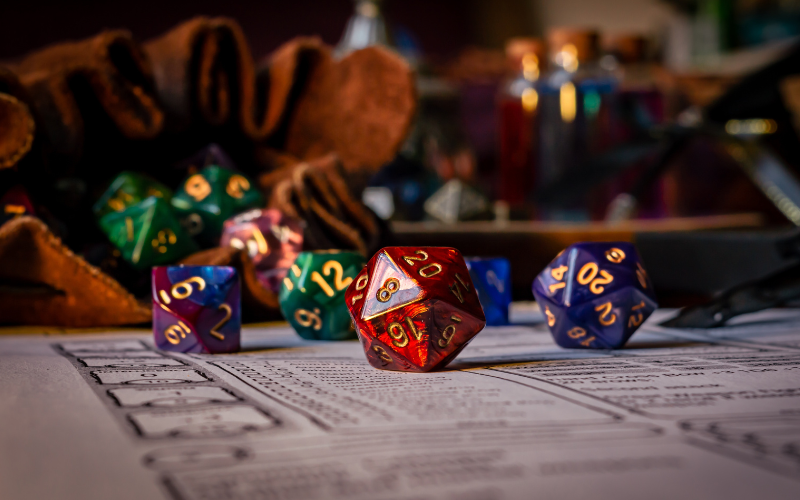 Close up of multi-sided dice used in Dungeons and Dragons spilling out of a leather pouch