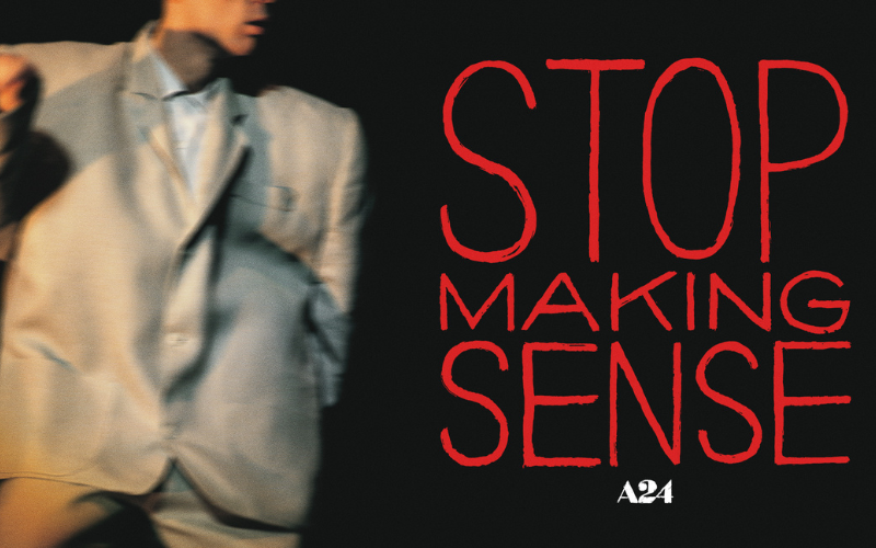 An image of David Byrne dancing in his signature oversized suit- next to him in red letters it reads "stop making sense"