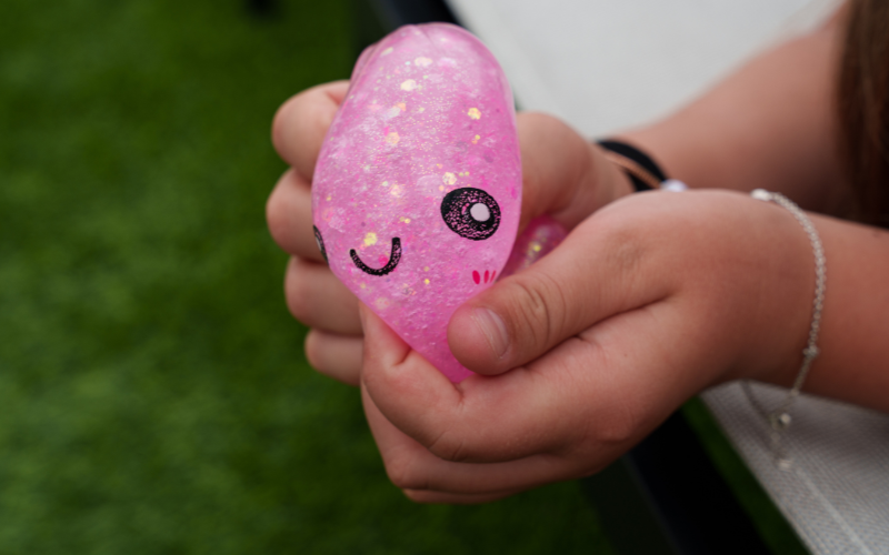 a pink squishy in the hands of a little girl